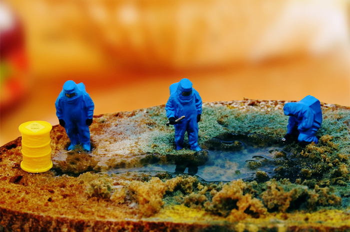 A miniature of a hazmat zone, with small figures dressed in containment suits investigating a spill.